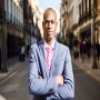 Portrait of handsome black man wearing suit in urban background
